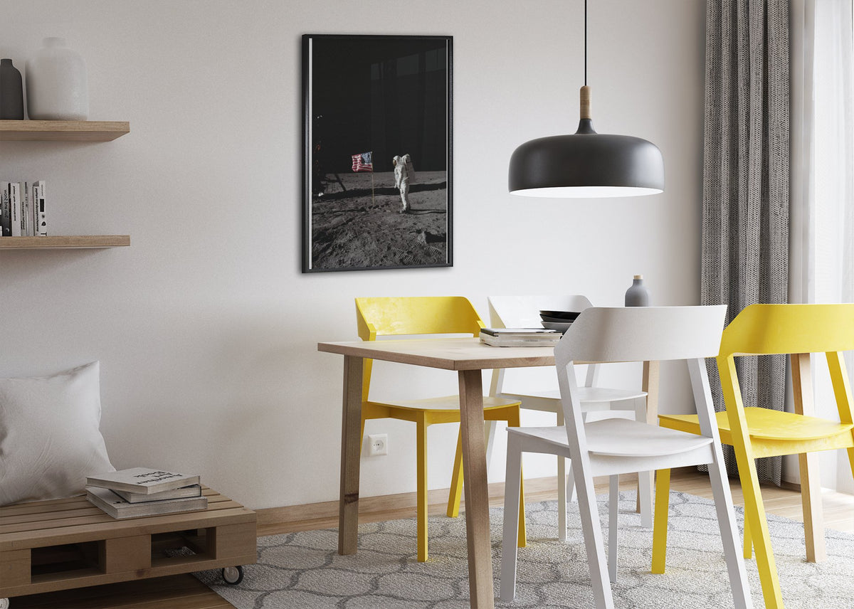 Buzz Aldrin with the US flag on the Moon poster framed above a dining table