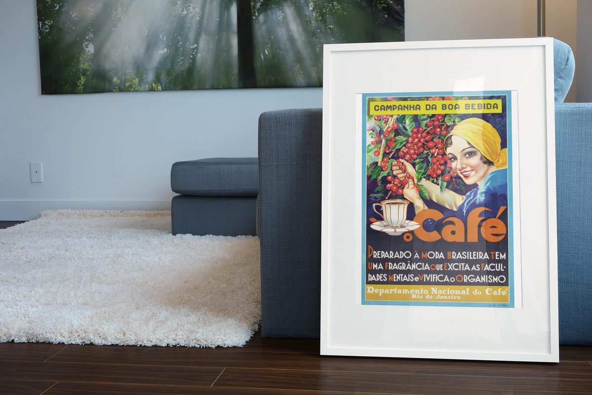 Cafe Brazilian Coffee poster leaning beside a blue sofa