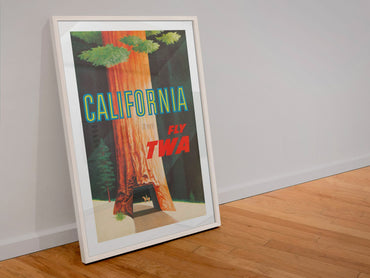 California Redwoods Fly TWA poster in a white frame leaning against a wall