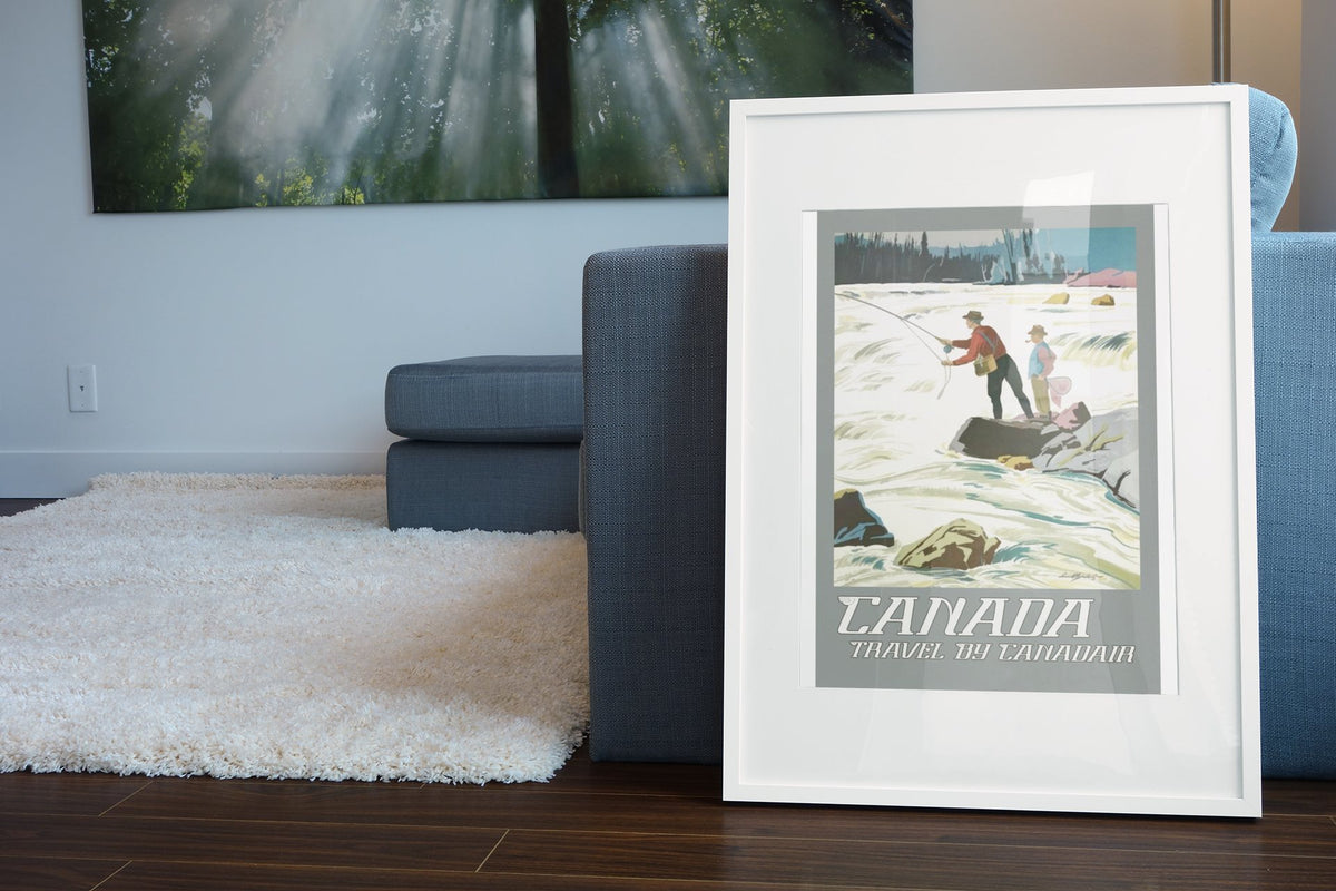 Canadian Pacific Fly Fishing poster leaning beside a blue sofa