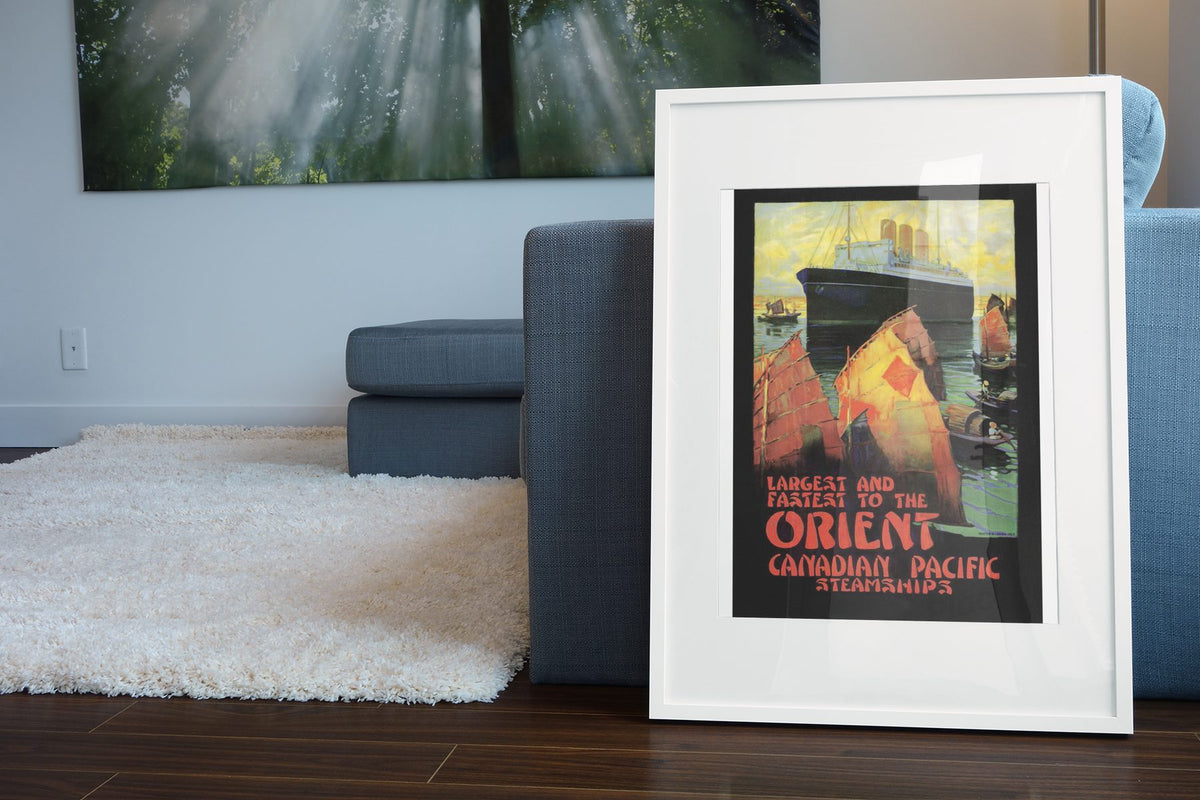 Canadian Pacific to the Orient poster leaning beside a blue sofa