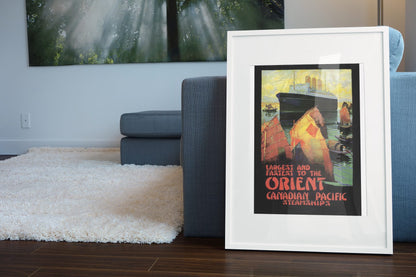Canadian Pacific to the Orient poster leaning beside a blue sofa