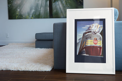 Canadian Pacific Locomotive 1950s poster leaning beside a blue sofa