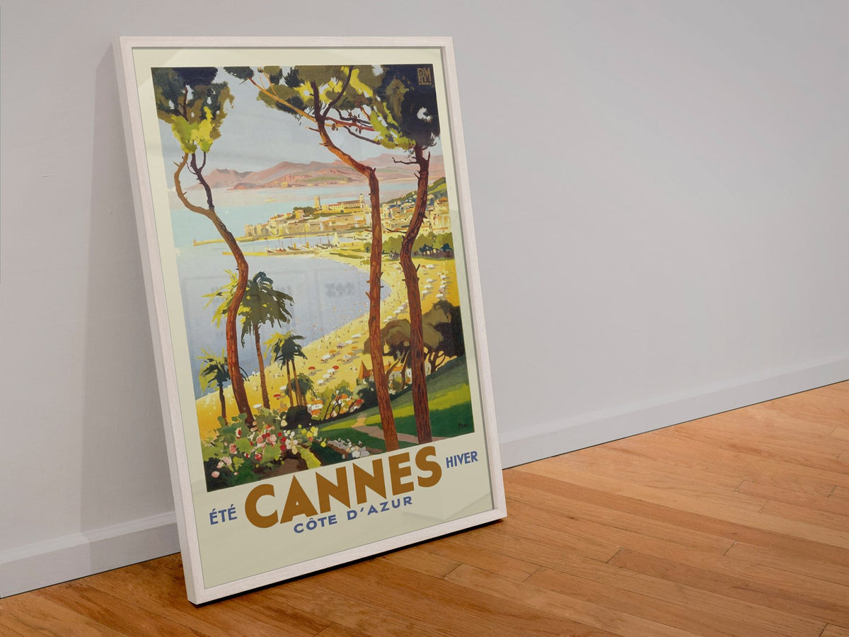Cannes Cote d Azur poster in a white frame leaning against a wall