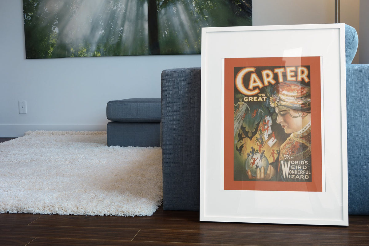 Carter the Great Weird Wonderful Wizard poster leaning beside a blue sofa