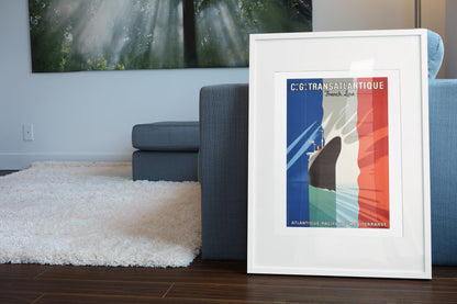 CGT Transatlantique French Line poster leaning beside a blue sofa