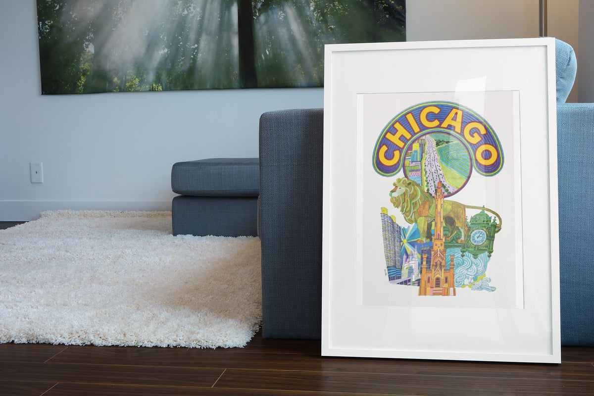 Chicago Fly TWA poster leaning beside a blue sofa