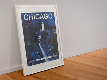Chicago Greyhound poster in a white frame leaning against a wall