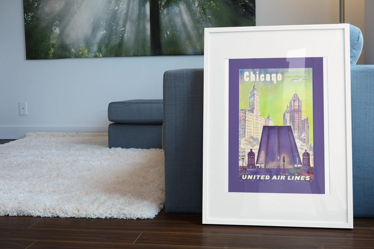 Chicago United Air Lines 1950s poster leaning beside a blue sofa