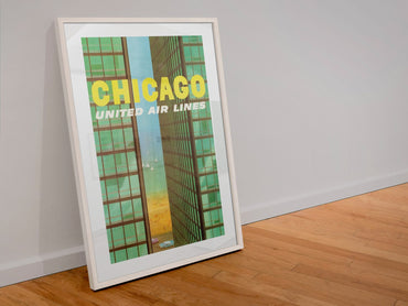 Chicago United Air Lines 1961 poster in a white frame leaning against a wall