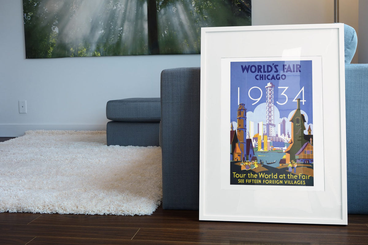 Chicago Worlds Fair Tour the World poster leaning beside a blue sofa