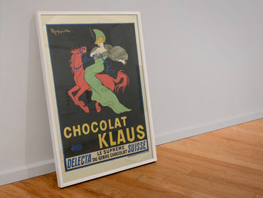 Chocolat Klaus Cappiello poster in a white frame leaning against a wall