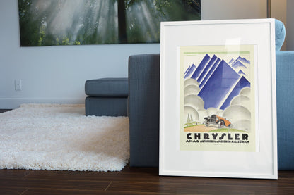 Chrysler AMAG Zürich poster in a white frame leaning beside a blue sofa