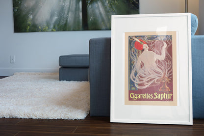 Cigarettes Saphir poster leaning beside a blue sofa