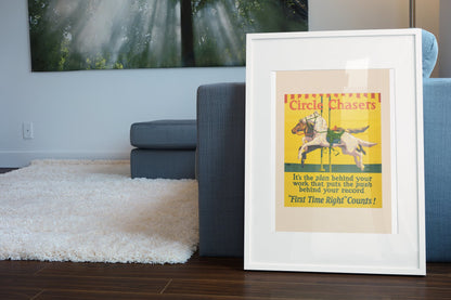 Circle Chasers poster in a white frame leaning beside a blue sofa