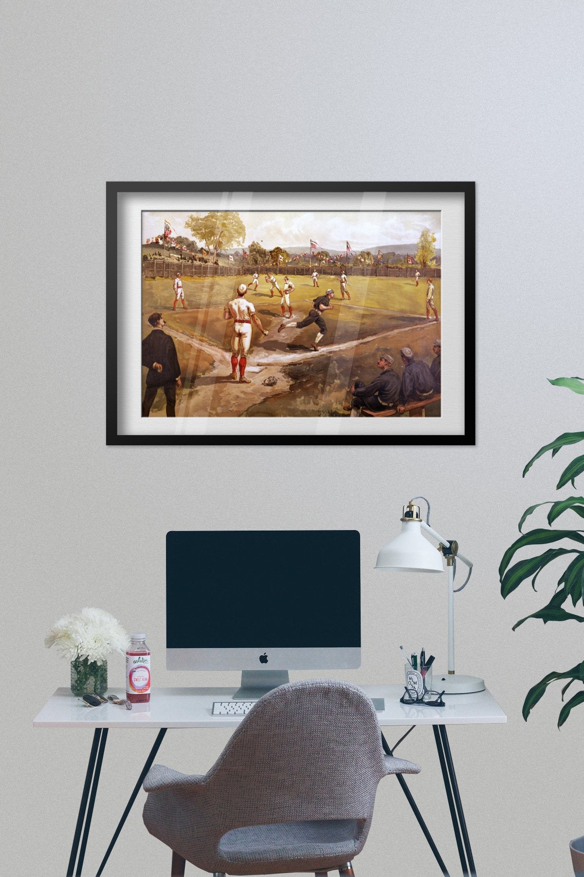 Baseball Game 1887 poster framed on a grey wall above a desk