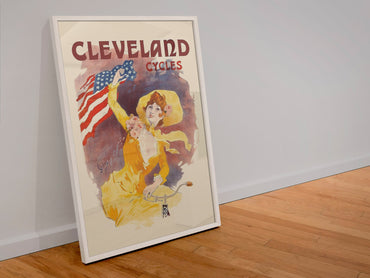Cleveland Cycles Cheret poster in a white frame leaning against a wall