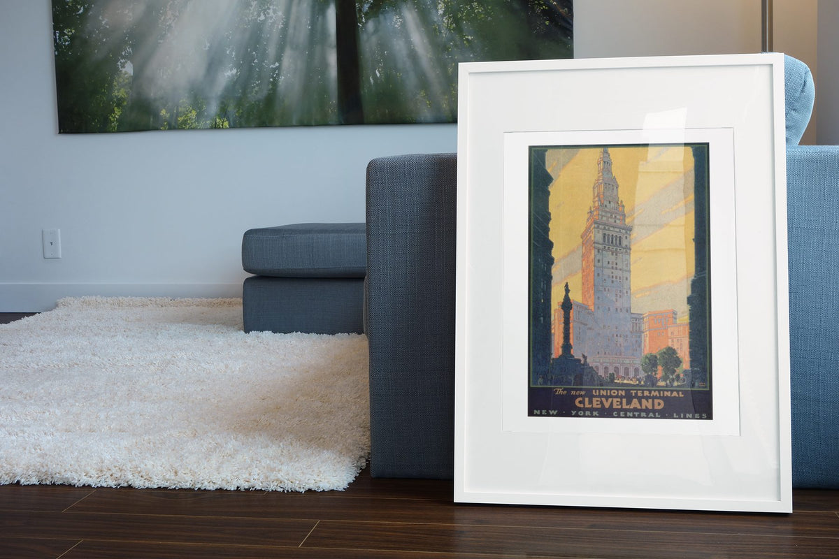 Cleveland Union Terminal — Leslie Ragan poster leaning beside a blue sofa