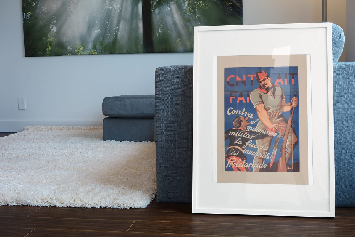 CNT AIT FAI Militiaman poster leaning beside a blue sofa