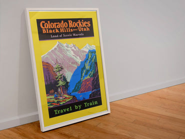 Colorado Rockies Black Hills Utah poster in a white frame leaning against a wall