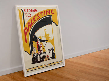 Come to Palestine poster in a white frame leaning against a wall