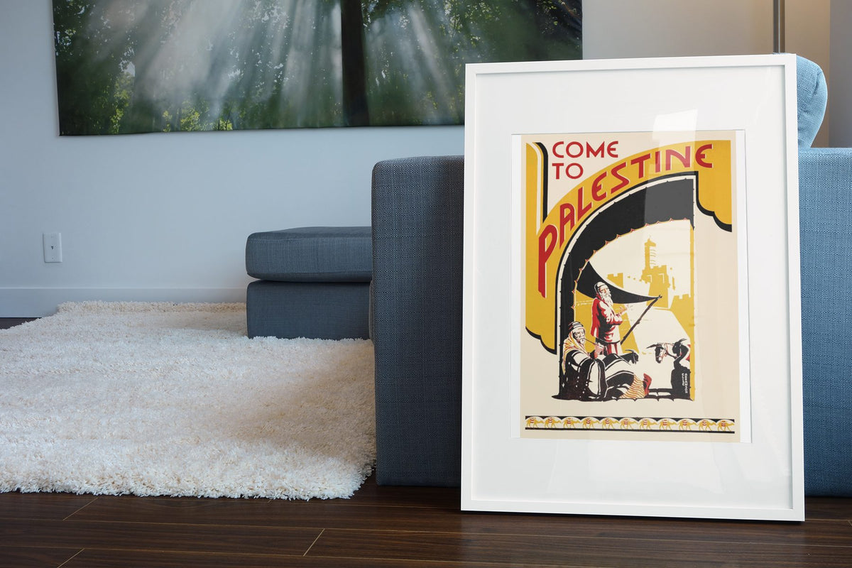 Come to Palestine poster leaning beside a blue sofa