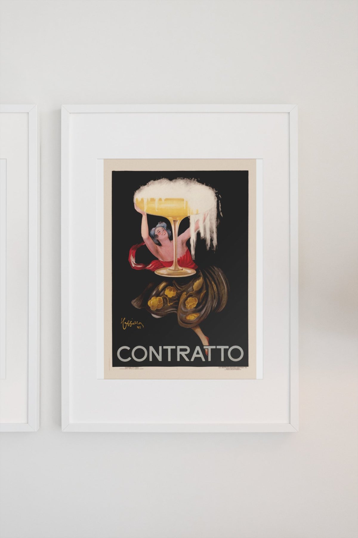 Contratto 1922 champagne by Cappiello poster in a white frame on a light wall