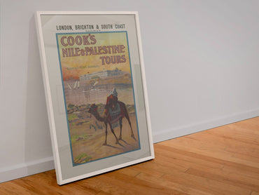 Cooks Nile and Palestine Tours poster in a white frame leaning against a wall