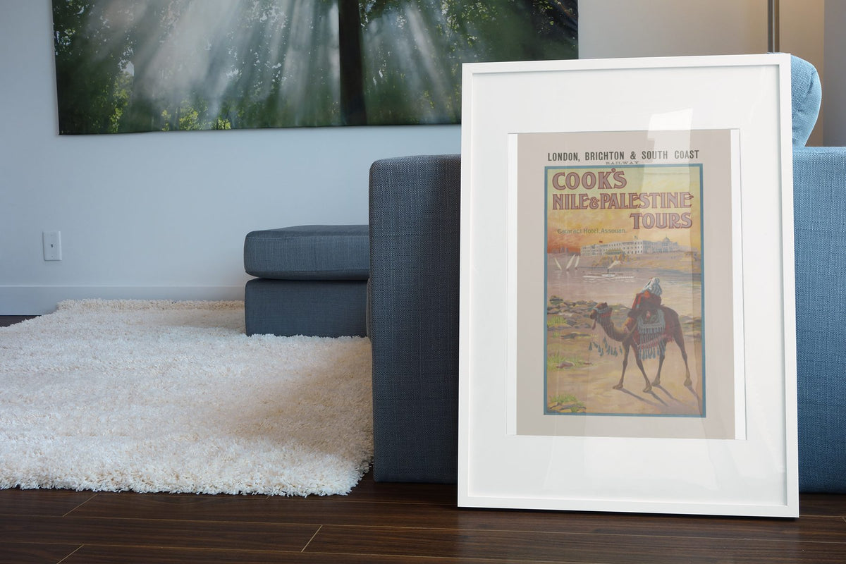 Cooks Nile and Palestine Tours poster leaning beside a blue sofa