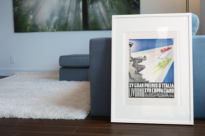 Coppa Ciano Livorno 1937 poster in a white frame leaning beside a blue sofa