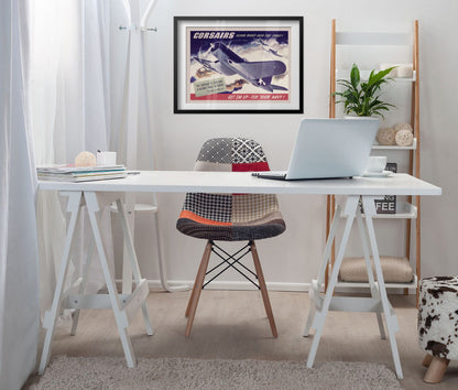 Corsairs Climb Right into the Fight poster framed above a white desk in a home office