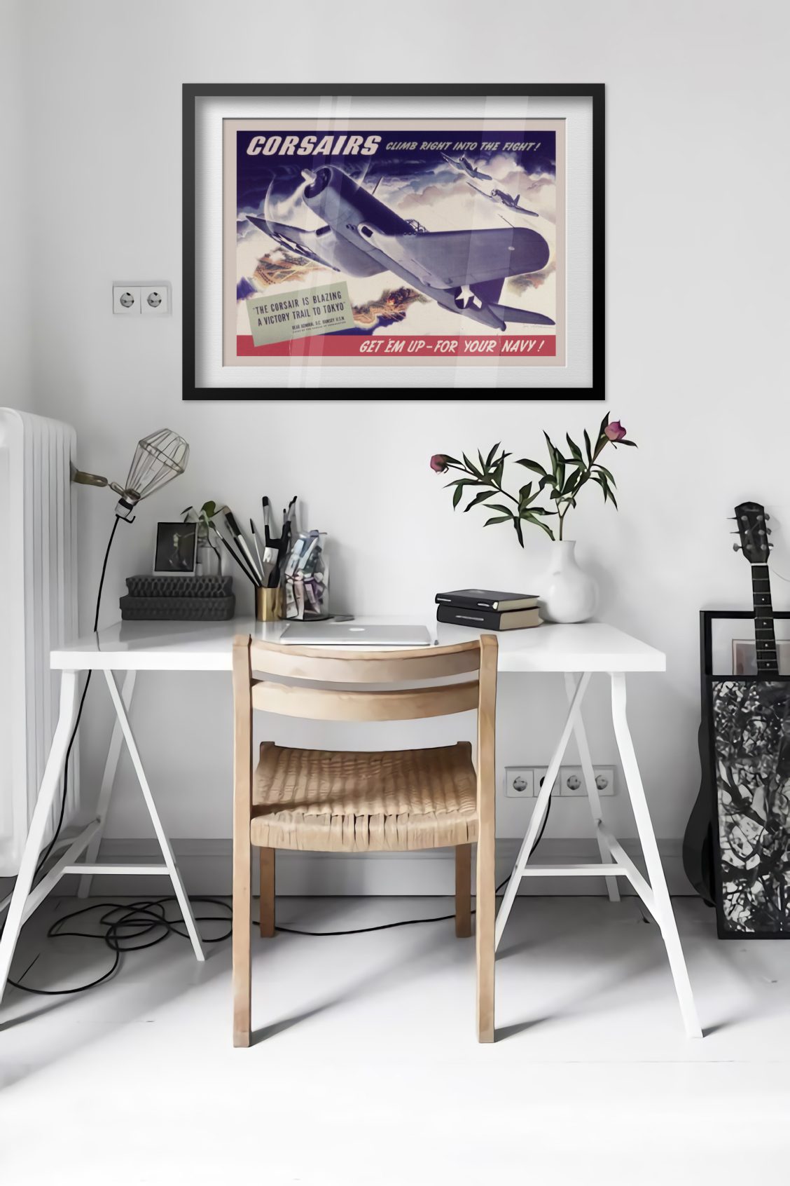 Corsairs Climb Right into the Fight poster framed above a desk in a bright white room