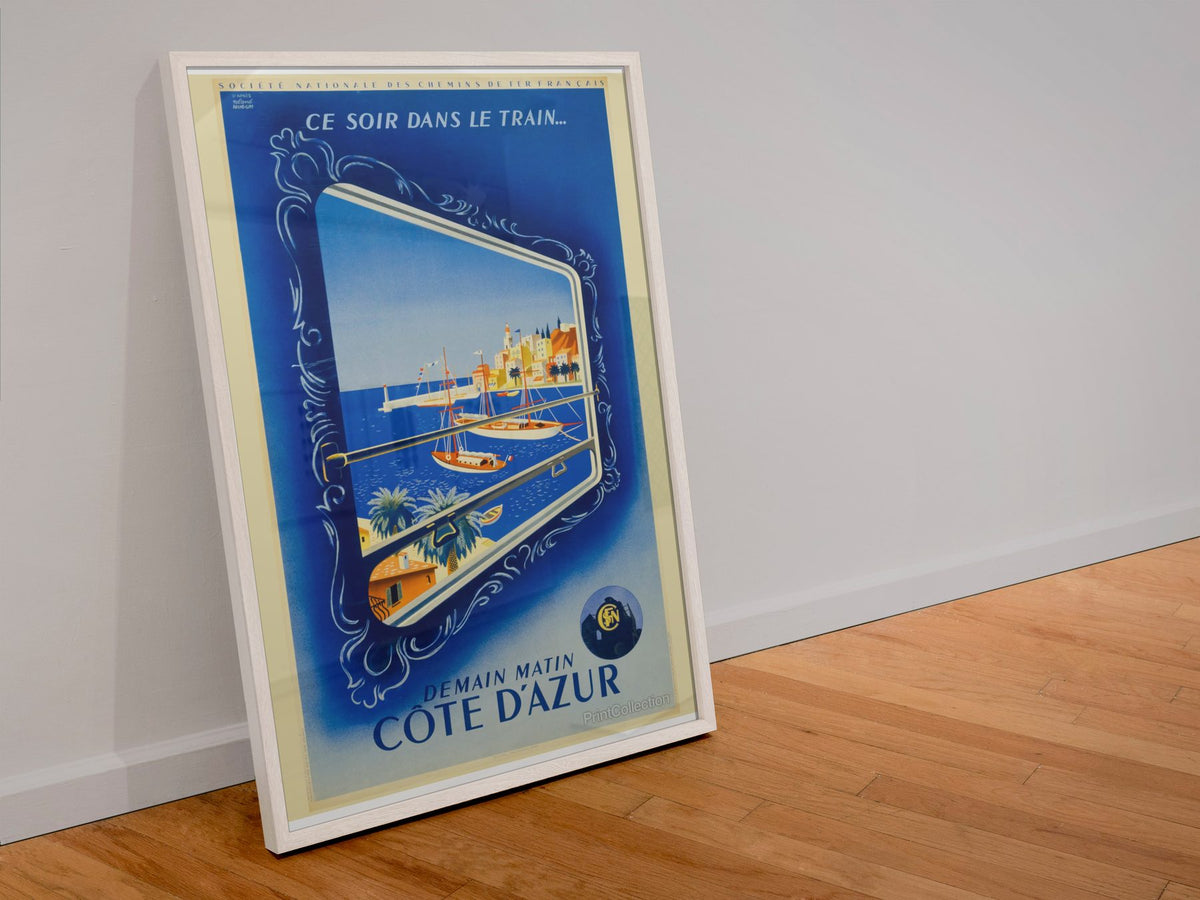 Cote d Azur by Train poster in a white frame leaning against a wall