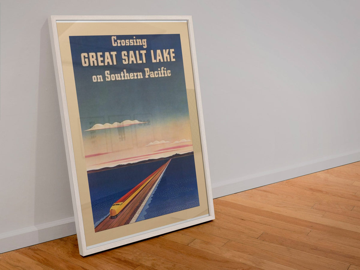 Crossing Great Salt Lake Southern Pacific poster in a white frame leaning against a wall