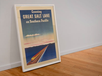 Crossing Great Salt Lake Southern Pacific poster in a white frame leaning against a wall