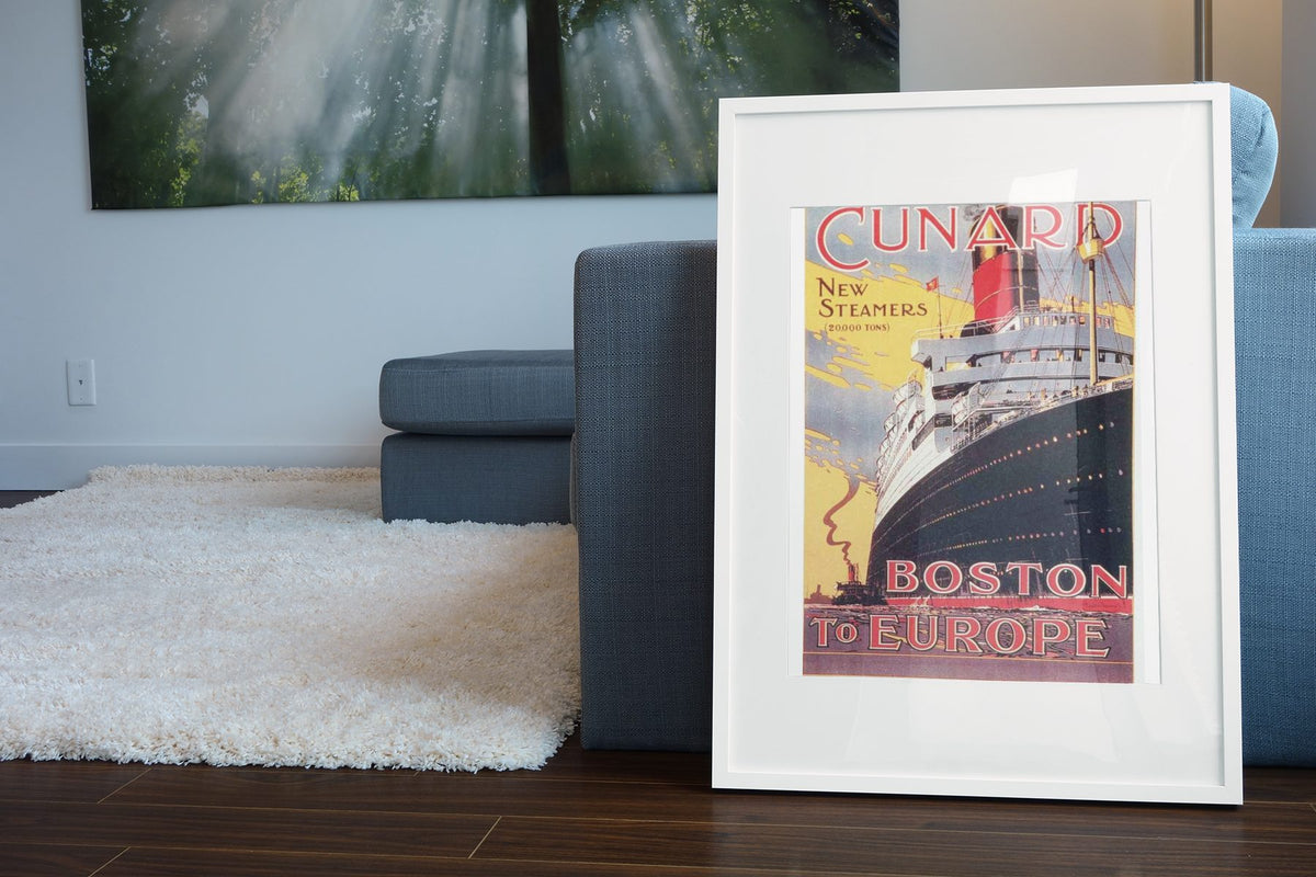 Cunard — Boston to Europe poster leaning beside a blue sofa