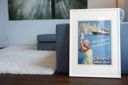 Cunard White Star America by Queen Mary poster leaning beside a blue sofa