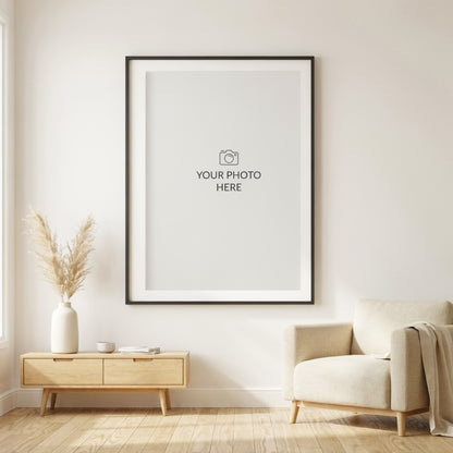 Custom photo print, vertical: large black frame with a Your Photo Here placeholder in a bright Scandinavian living room