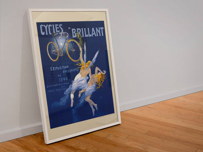 Cycles Brillant 1900 bicycle poster in a white frame leaning against a wall