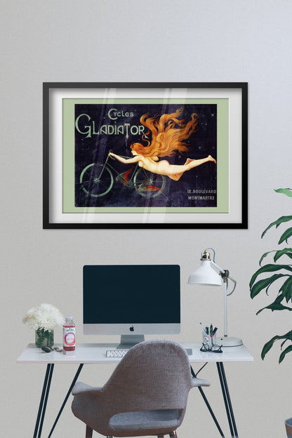 Cycles Gladiator poster framed on a grey wall above a desk