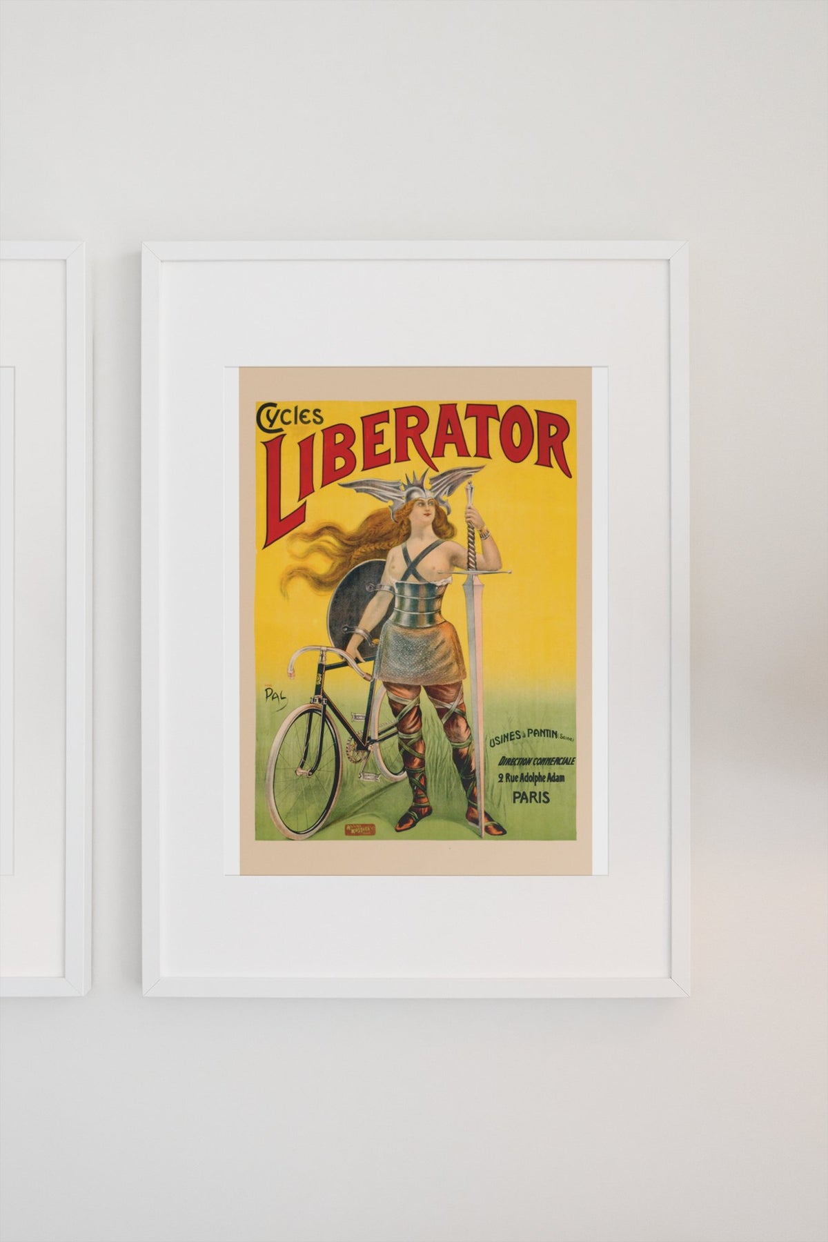 Cycles Liberator 1899 bicycle poster in a white frame on a light wall