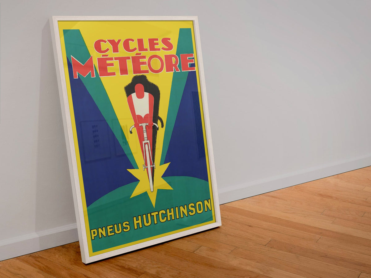 Cycles Meteore Hutchinson poster in a white frame leaning against a wall