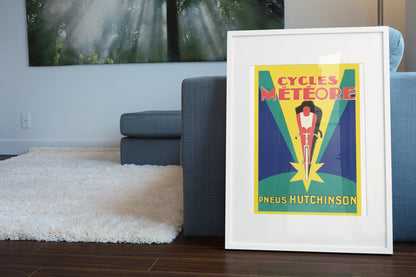Cycles Meteore Hutchinson poster leaning beside a blue sofa