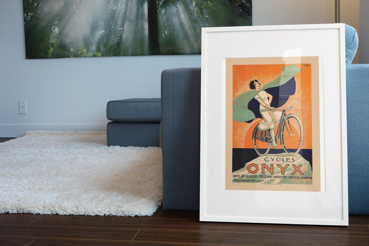 Cycles Onyx poster leaning beside a blue sofa