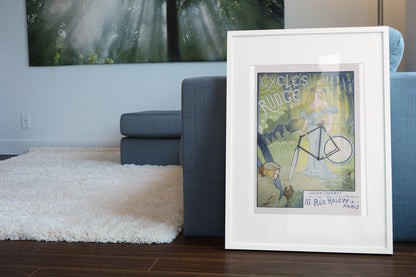 Cycles Rudge Paris poster leaning beside a blue sofa