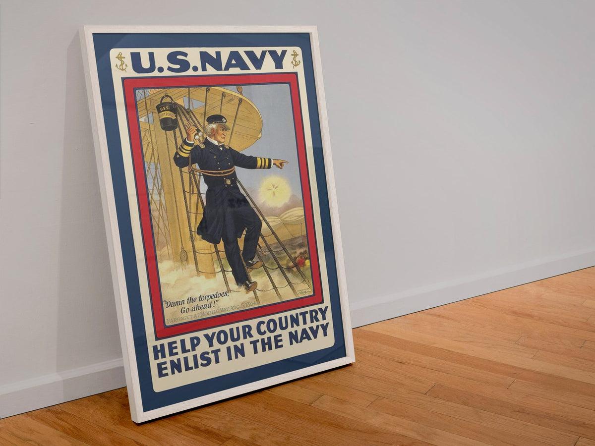 Damn the Torpedoes Enlist in the Navy poster in a white frame leaning against a wall