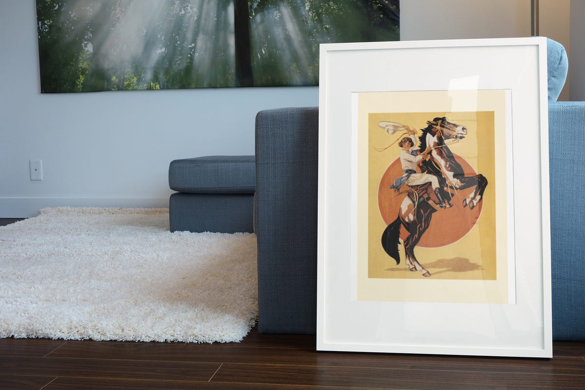 Days of the Golden West Rodeo poster leaning beside a blue sofa