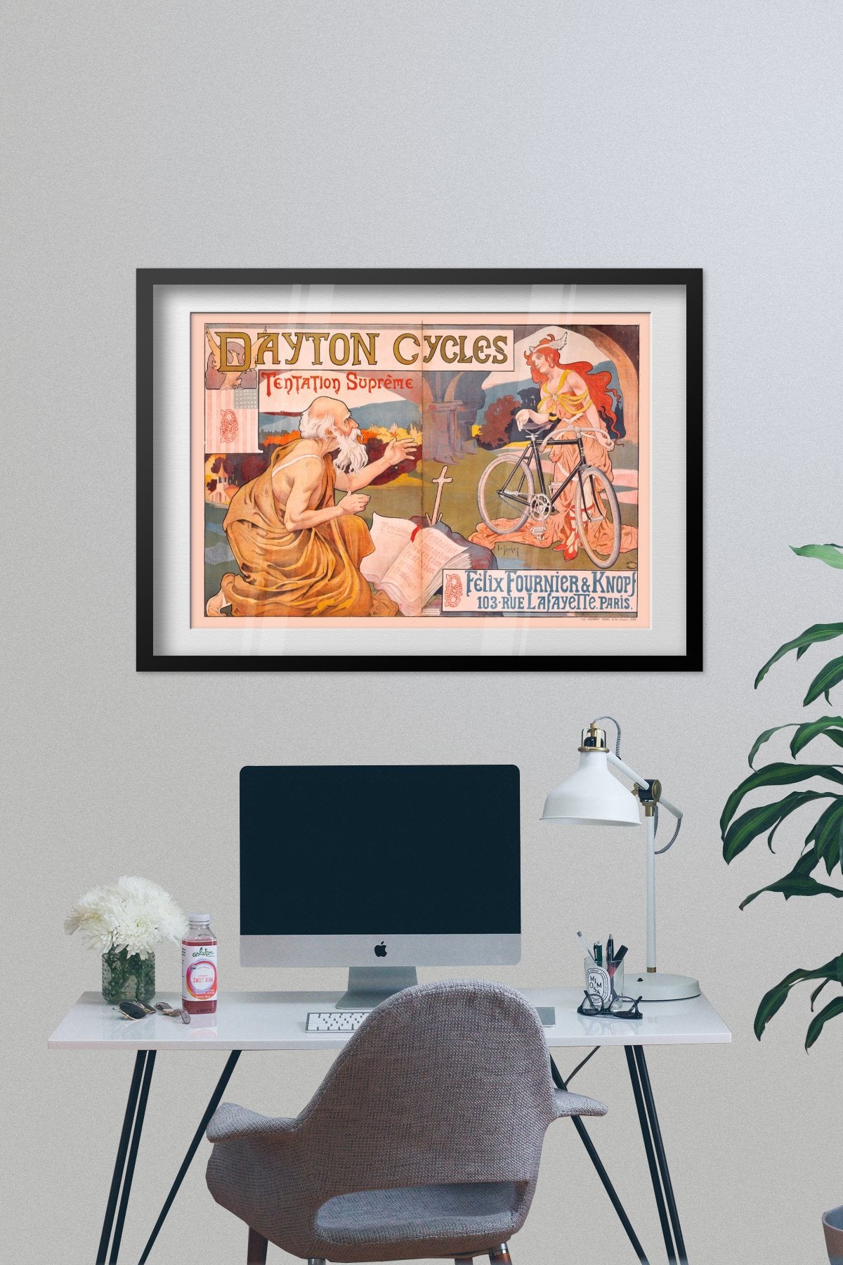 Dayton Cycles Tentation Supreme poster framed on a grey wall above a desk