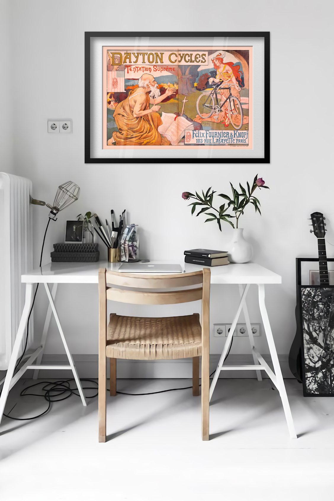 Dayton Cycles Tentation Supreme poster framed above a desk in a bright white room