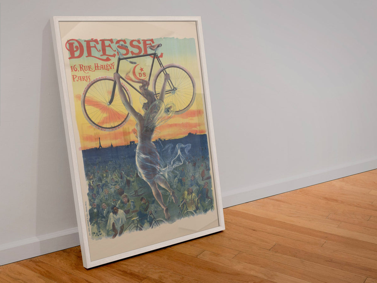 Deesse Bicycles Paris poster in a white frame leaning against a wall